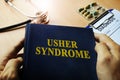 Hands holding book Usher syndrome.