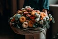 Hands holding bouquet of beautiful orange gerbera flowers. Generative AI. Royalty Free Stock Photo