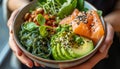 Hands holding bowl with salmon, wakame and avocado. AI generated.