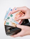 hands holding brown leather wallet full of money - various Euros Eur banknotes Royalty Free Stock Photo
