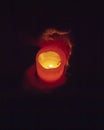 Hands holding burning candle in the dark Royalty Free Stock Photo