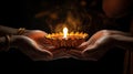 Hands holding burning diwali oil lamp, isolated on black background Generative AI