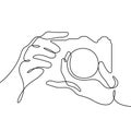 Camera in photographer`s hands continuous line vector illustration