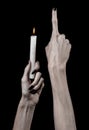 Hands holding a candle, a candle is lit, black background, solitude, warmth, in the dark, Hands death, hands witch Royalty Free Stock Photo