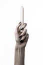 Hands holding a candle, a candle is lit, white background, solitude, warmth, in the dark, Hands death, hands witch Royalty Free Stock Photo