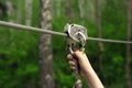 Hands holding carabiner on zip line Royalty Free Stock Photo