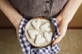Hands holding ceramic plate with biscuits in the shape of a heart, St.Valentine`s Day concept