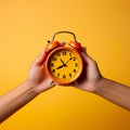 hands holding a clock against a solid background, embodying the concept of time.