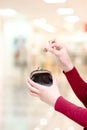 Hands holding coin and money pouch in mall Royalty Free Stock Photo