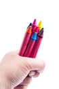 Hands holding color crayons