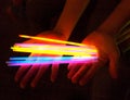 Hands holding Colourful Glow sticks Royalty Free Stock Photo
