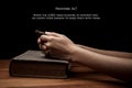 Hands holding a cross on holy Bible with verse Royalty Free Stock Photo