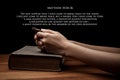 Hands holding a cross on holy Bible with verse Royalty Free Stock Photo