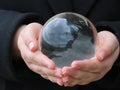 Hands holding crystal ball