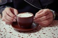 Hands holding a cup of caffe mocha