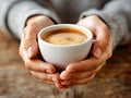 Hands holding a cup of coffee. Close-up a cup of coffee held in hands. Royalty Free Stock Photo