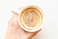 Hands holding cup of hot tea. Ginger tea with lemon. A Cup of tea is held by a woman's hand. Season of colds and infections. Royalty Free Stock Photo