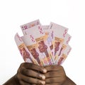 hands holding 3D rendered 1000 CFA Franc notes. closeup of Hands holding CFA franc currency notes Royalty Free Stock Photo