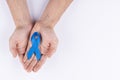 Hands holding dark blue ribbon. White background