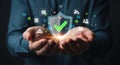 Hands holding digital shield with glowing checkmark symbolizing data security and protection Royalty Free Stock Photo