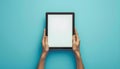 Hands Holding a Digital Tablet on a Blue Background Royalty Free Stock Photo