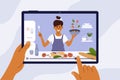 Hands holding digital tablet with young woman on screen preparing healthy food in kitchen Royalty Free Stock Photo