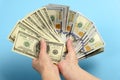 Hands holding a 100 dollar bill. Hands hold a lot of money. Fan out of bills of American dollars Royalty Free Stock Photo