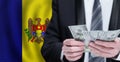 Hands holding dollar money on flag of Republica Moldova