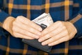 Hands holding dollars and small money pouch Royalty Free Stock Photo