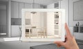Hands holding and drawing on tablet showing real finished minimalist white kitchen. Modern kitchen CAD sketch in the background, a