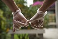 Hands holding each other with the little finger wearing sanitary gloves. Close up. COVID-19 Royalty Free Stock Photo