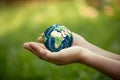 hands holding earth global over blurred nature background. Earth Day. Generative AI Royalty Free Stock Photo