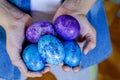 Hands holding Easter Eggs. Boy in blue shirt drawing Easter Eggs at Home. Easter Holiday at Home. Blue Easter Eggs.