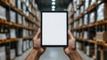 Employee hands holding digital tablet with blank screen, managing logistics and inventory modern a warehouse Royalty Free Stock Photo