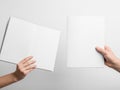 Hands holding empty white paper sheets Royalty Free Stock Photo