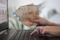 Hands holding euro money and using laptop Royalty Free Stock Photo