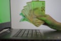 Hands holding euro money and using laptop with green screen Royalty Free Stock Photo