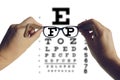 Hands holding eyeglasses with visual test chart. Eyesight optician concept Royalty Free Stock Photo