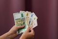 Hands holding a fan of Bulgarian banknotes of various denominations against a blurred background Royalty Free Stock Photo