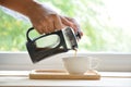 Hands holding french press coffee pot Royalty Free Stock Photo