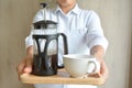 Hands holding french press coffee pot Royalty Free Stock Photo