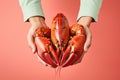 Hands holding fresh lobster on pastel background, fresh food ingredients, Healthy food