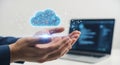 Hands holding futuristic glowing cloud hologram with laptop screen showing data Royalty Free Stock Photo