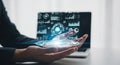 Hands holding futuristic glowing interface with data and charts displayed digitally Royalty Free Stock Photo