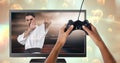 Hands holding gaming controller with martial arts fighter player on television