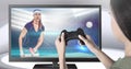 Hands holding gaming controller with table tennis player on television Royalty Free Stock Photo