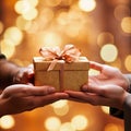 2 hands holding a gift box Royalty Free Stock Photo
