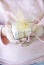 hands holding gift box with ribbon Royalty Free Stock Photo