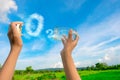 Hands holding glass jar for keeping fresh air, O2 cloud word with a blue sky in the background