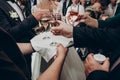 Hands holding glasses of champagne. stylish happy wedding couple toasting with family, celebrating wedding. space for text. luxury Royalty Free Stock Photo